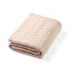 Merino wool blanket, light beige cable-knit fold