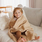 Dark beige merino wool blanket draped over a child on a bed