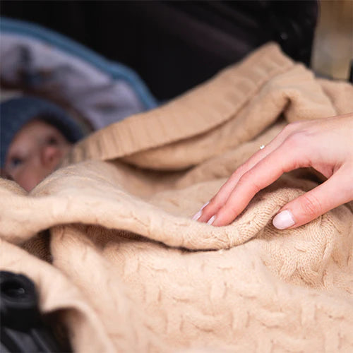 Dark beige merino wool blanket close-up with soft cable knit texture