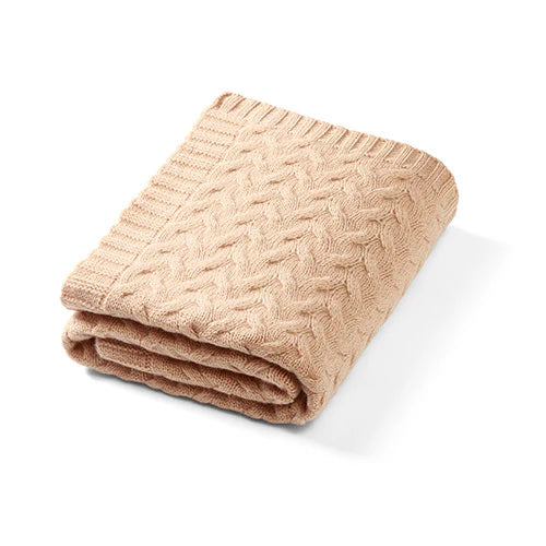 Merino wool blanket in dark beige knit, folded with textured cable pattern