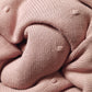 Pink flannel-lined cotton blanket corner with ribbed knit edge
