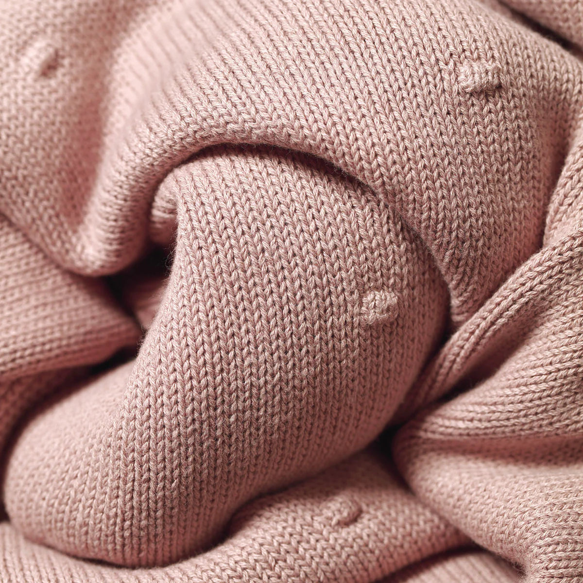 Pink flannel-lined cotton blanket corner with ribbed knit edge