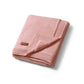 Pink cotton blanket with flannel lining, folded and bound edge