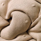Flannel-lined cotton blanket close-up with thick knit texture and folded seam