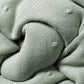 Green knit blanket corner with textured ribbed trim and folded edge