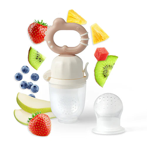 Beige baby food feeder with twist ring and mesh nipple near fruit pieces