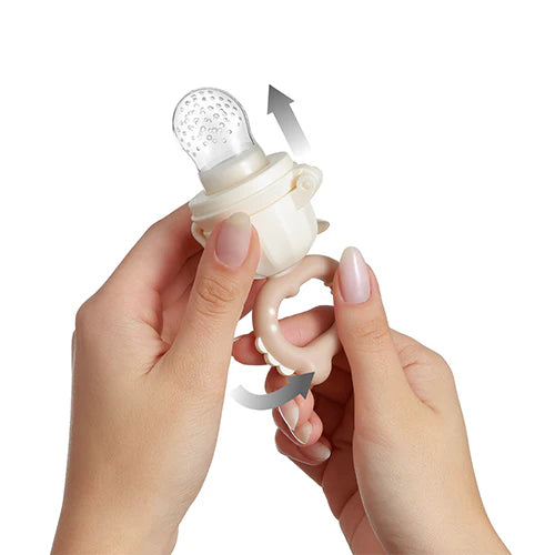 Beige baby food feeder close-up with mesh nipple and twist ring
