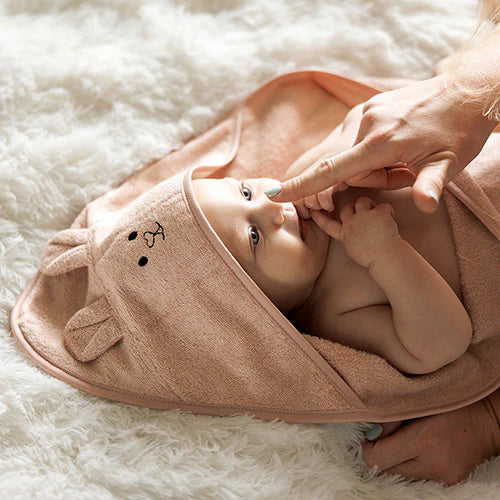 Pink hooded baby towel with face applique, laid open