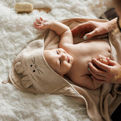 Beige bamboo hooded towel with mouse ears and face, baby wearing hood