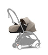 Newborn stroller pack with beige carrycot and seat, gray frame, front wheels