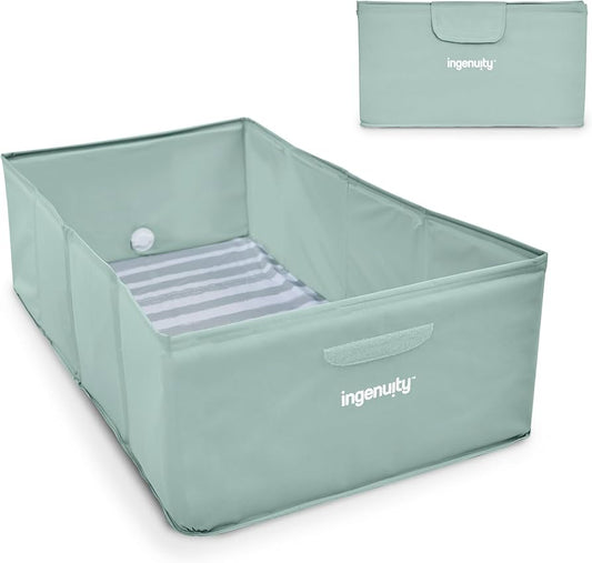 Mint foldable toddler bathtub with striped bottom pad and carry handle, shown unfolded