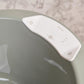 Light green bathtub rim with white control panel and button icons
