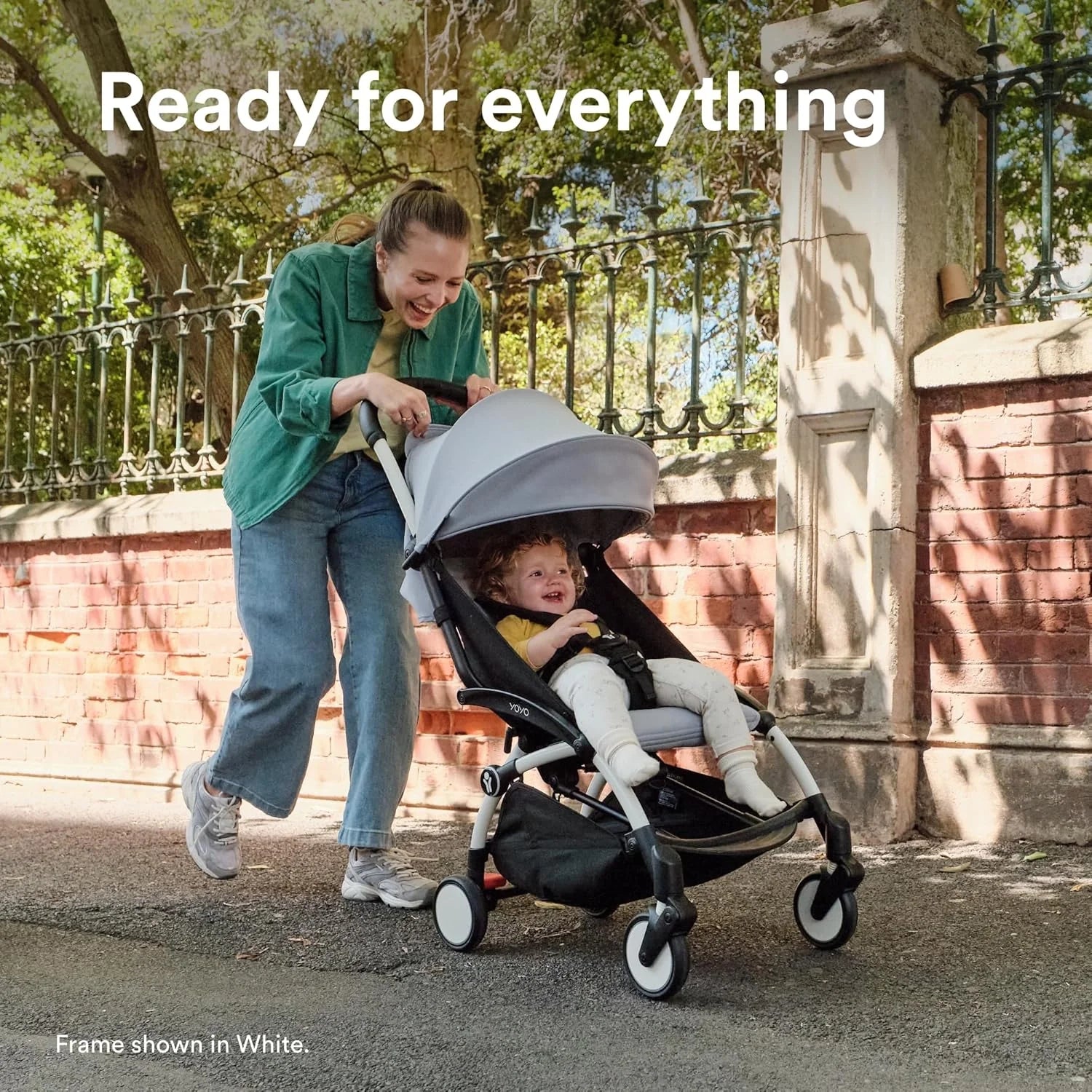 Light gray canopy stroller with dark seat and front wheels, angled view.