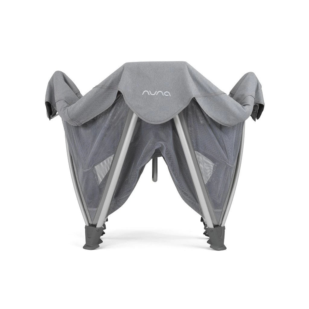 Grey mesh bassinet with canopy shade and folding legs, nuna logo on fabric