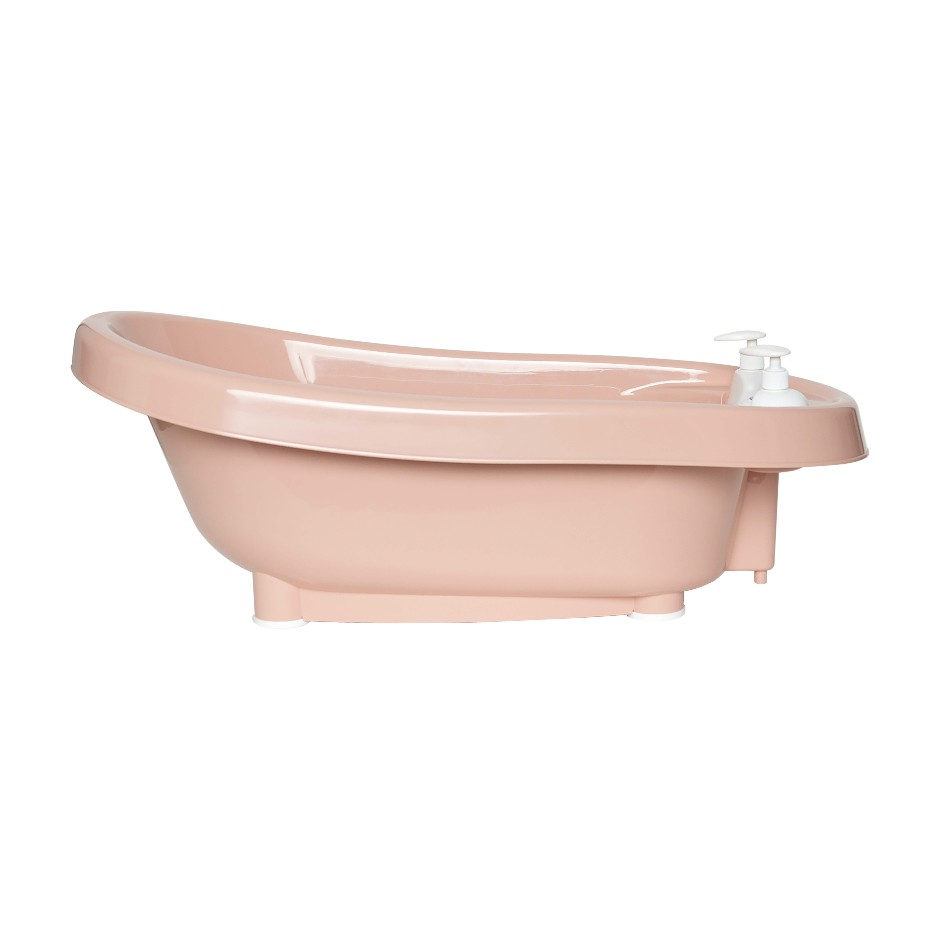 Pale pink freestanding bathtub with built-in faucet and handheld soap dispenser