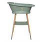 Green bathtub on wooden stand legs with seahorse decal