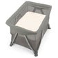 Grey zippered bassinet with padded mattress and mesh sides on folding stand