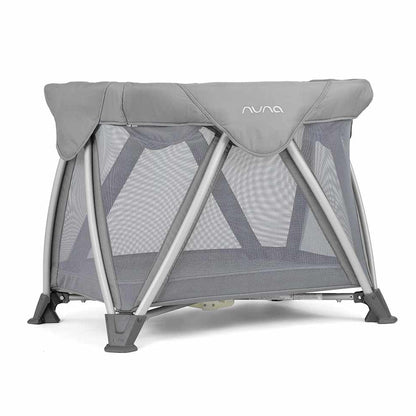 Nuna air bassinet with gray canopy and zippered mesh sides, on folding stand