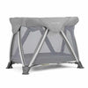 Nuna bedside bassinet with gray canopy, mesh sides, and foldable stand