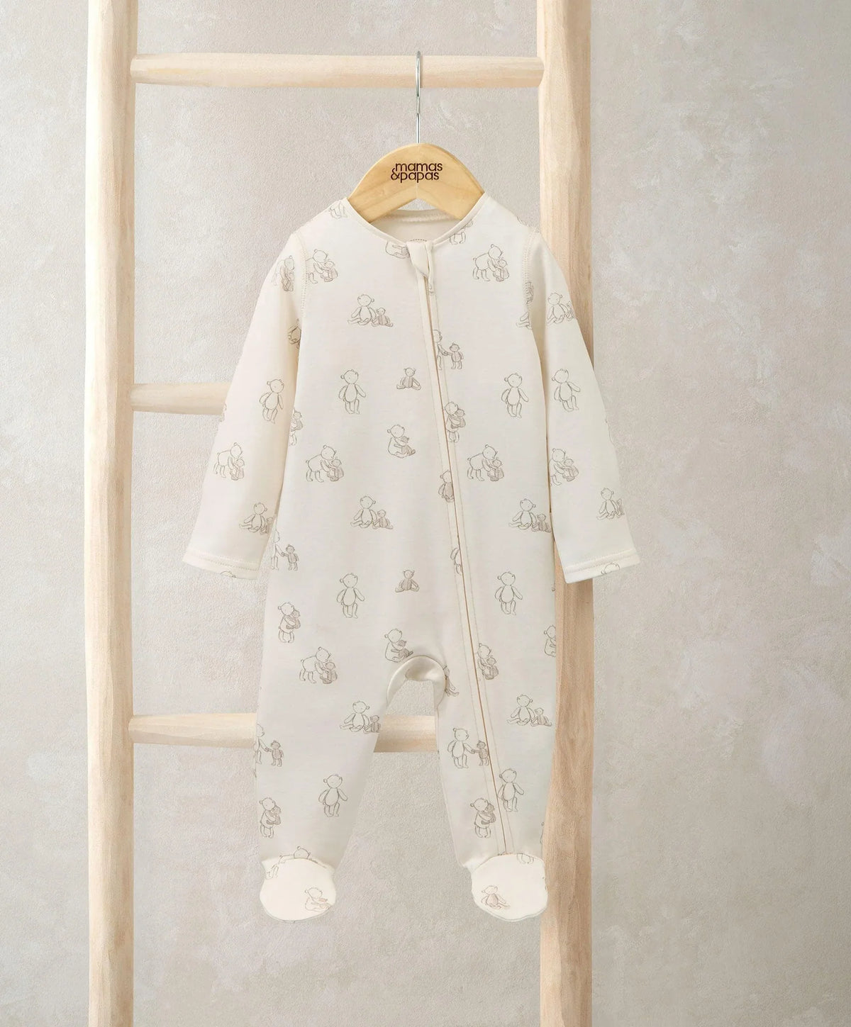 Cream bear-print footed onesie with front zip and long sleeves