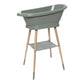 Freestanding light green baby bath tub with raised legs and side shelf