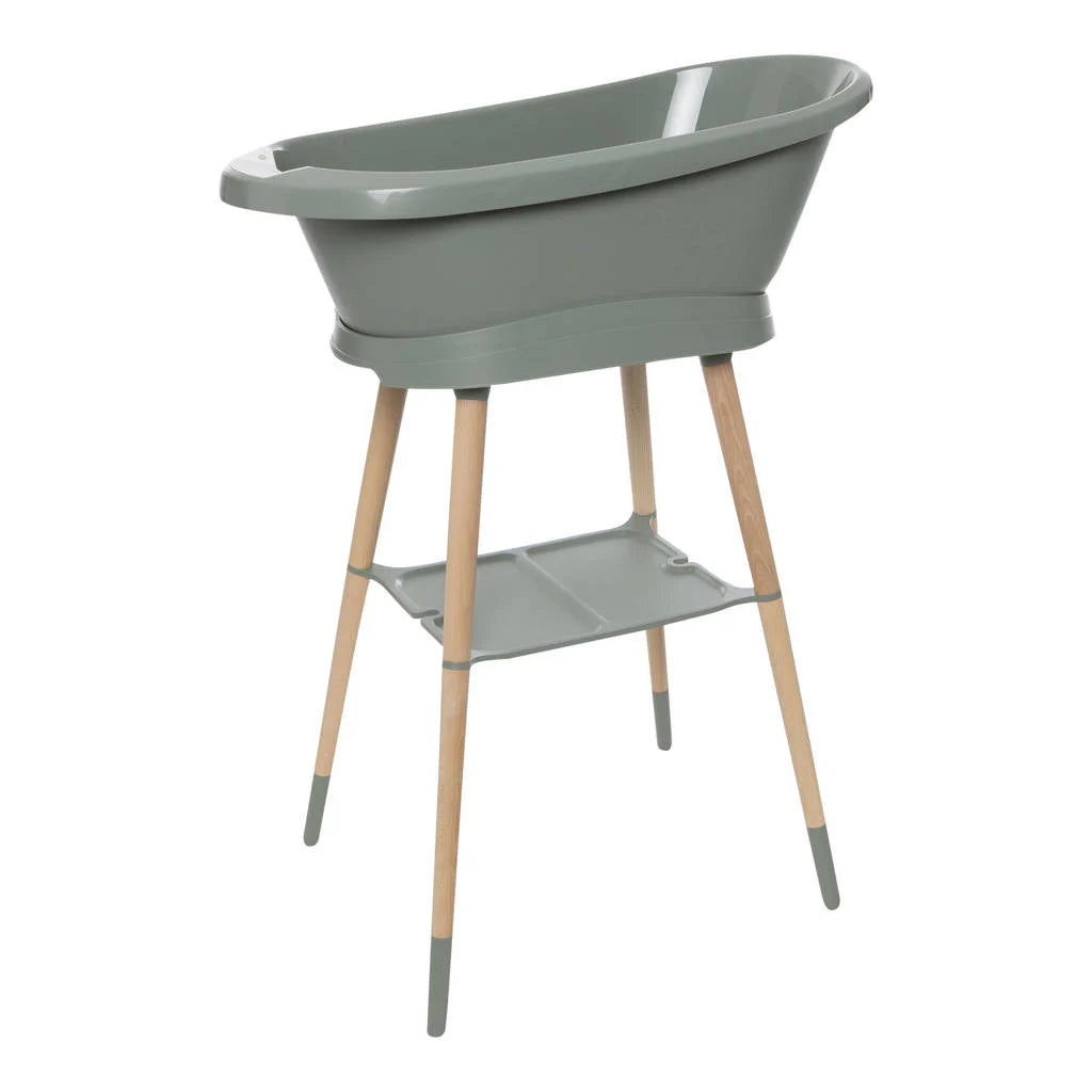 Freestanding light green baby bath tub with raised legs and side shelf
