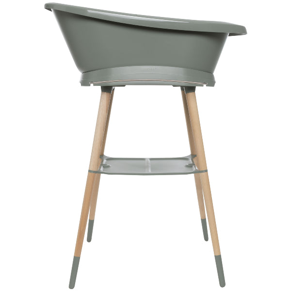 Light green baby bathtub on wooden legs with front support shelf