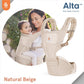 Beige hip seat baby carrier worn with padded shoulder straps and front panel