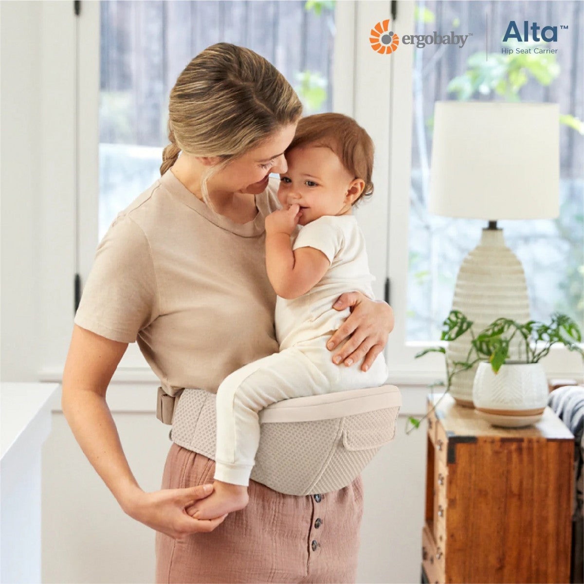 Beige hip seat baby carrier worn at waist with adjustable shoulder straps