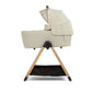 Ocarro 2 carrycot in cream with open hood and fabric panel on tripod legs