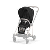 Black stroller seat pack with padded harness and canopy, side view