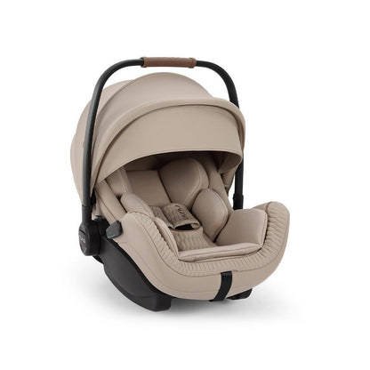 Beige rear-facing car seat with canopy and padded infant insert, carry handle