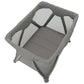 Grey bassinet with open mesh sides and curved padded frame, folding base
