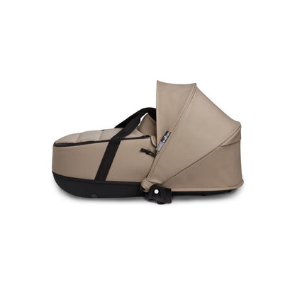Beige newborn shell with curved canopy and black handle strap, for stroller frame